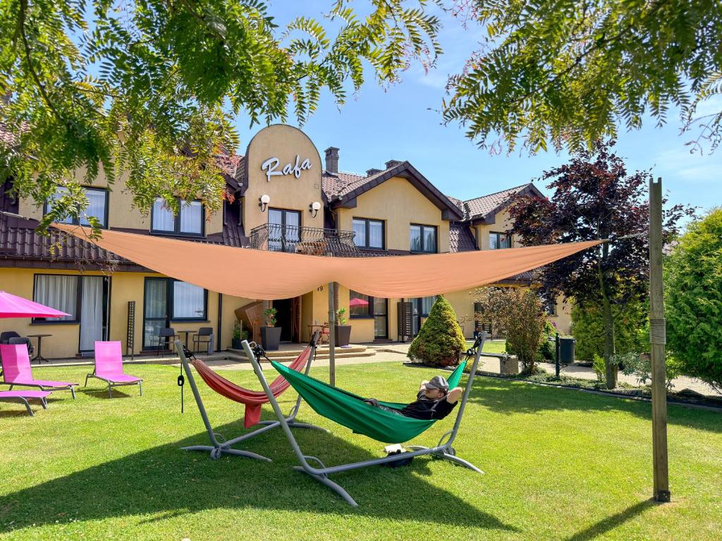 a person laying in a hammock in a yard at Rafa in Rowy