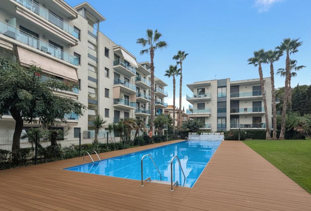 a swimming pool in front of a apartment building at Relax en Lloret con Gym y Piscina by Host&Joy in Lloret de Mar