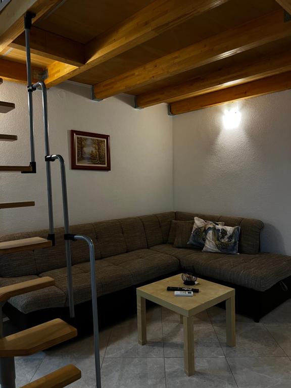 a living room with a couch and a table at Tesla Apartman in Risan