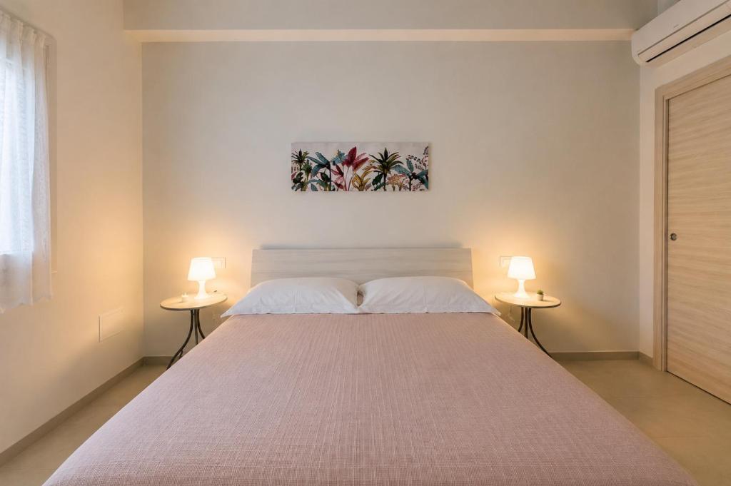 a bedroom with a large bed with two lamps at Borgo San Michele Bed & Breakfast in Calvisano