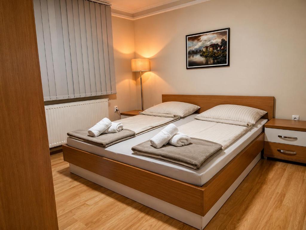 a bedroom with two beds in a room at Royal Apartmani in Negotin