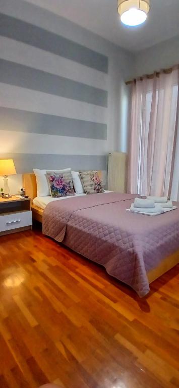 a bedroom with a large bed and a wooden floor at Anna's Cozy Place in Sparta