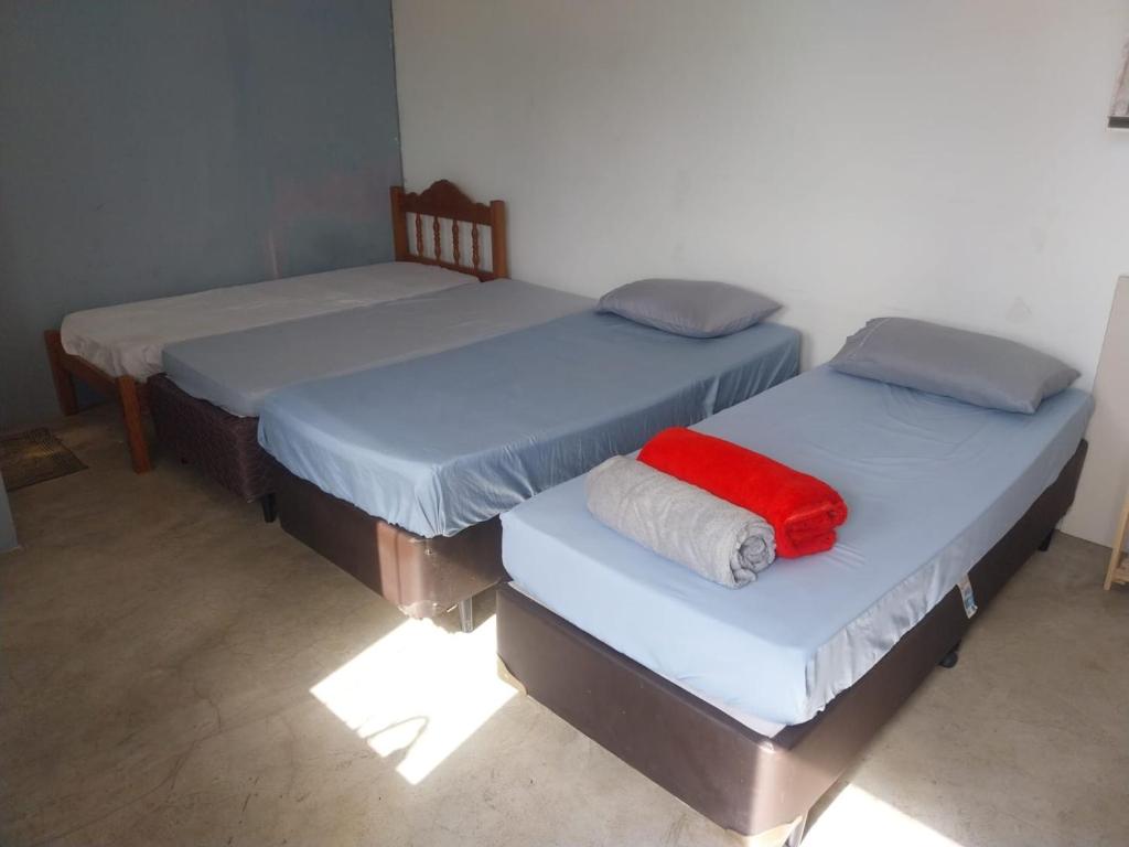 two beds with blue and red sheets in a room at Quarto superior Privativo in Itupeva