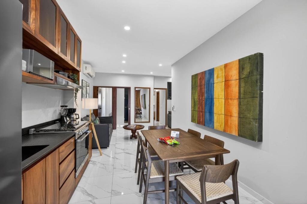 a kitchen and dining room with a table and chairs at Unit Aguacates Romantic Zone in Puerto Vallarta