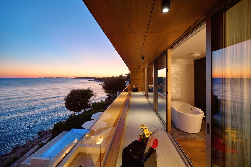 a bathroom with a view of the ocean at Aparatment house Gloss Primosten in Primošten