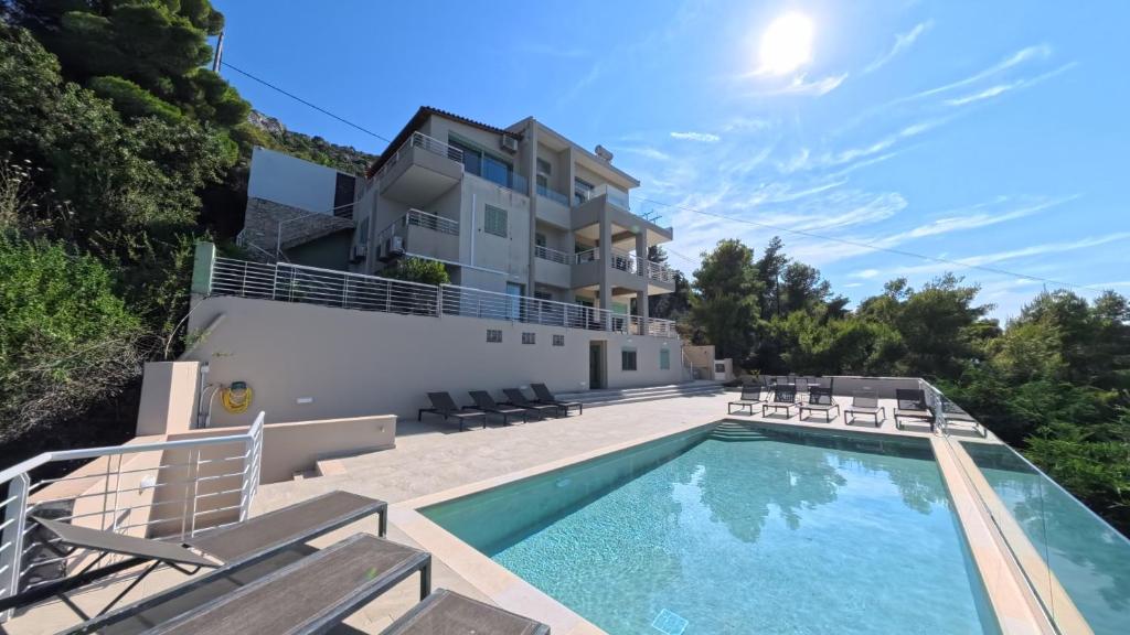 a villa with a swimming pool and a building at Theologos Ridge in Theologos