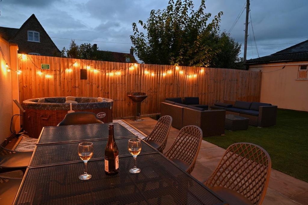 a patio with a table and two glasses of wine at The Nook in Claypits