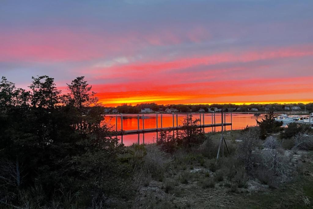 a sunset over a body of water with a marina at Waterfront Escape with Stunning Views on Bass River in West Dennis