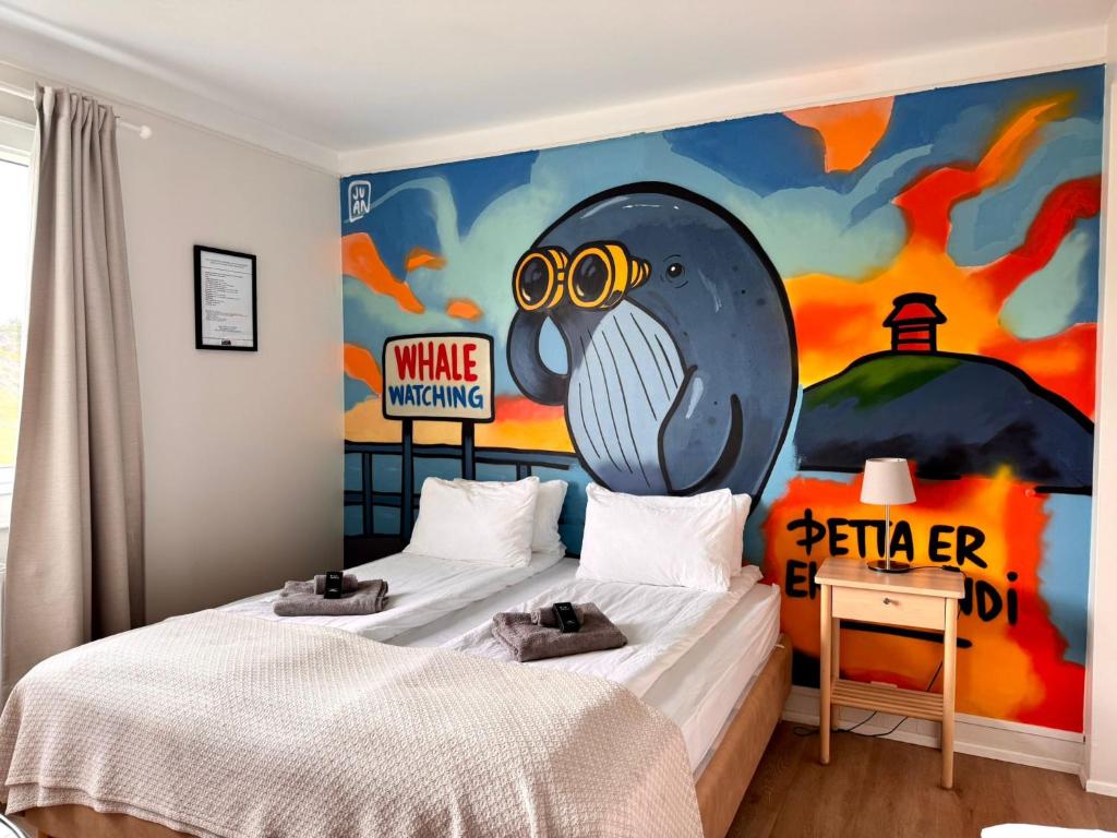 a bedroom with two beds and a painting on the wall at The Stykkishólmur Inn by Ourhotels in Stykkishólmur