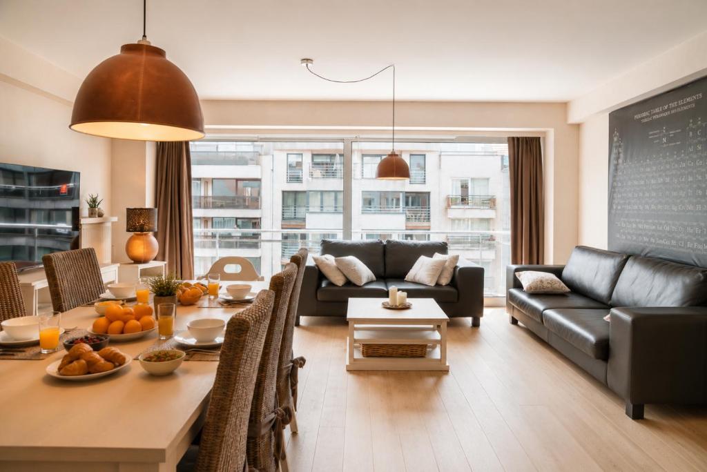 a living room with a couch and a table at Vertry at Sea, Luxury Apartment Knokke in Knokke-Heist