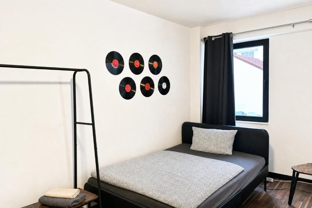 a bedroom with a bed and a window at Music Residence in Saarbrücken