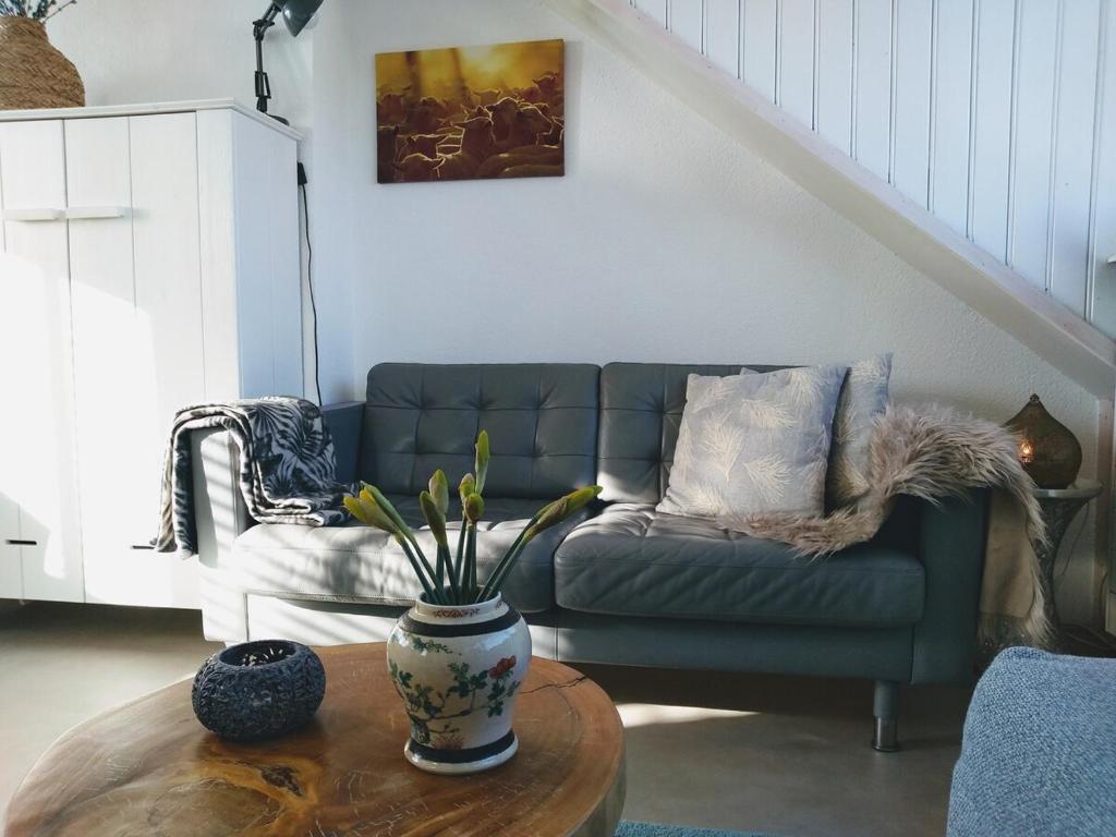 a living room with a couch and a table at Appartement Zuid 5 strand op 2 minuten lopen in Zandvoort