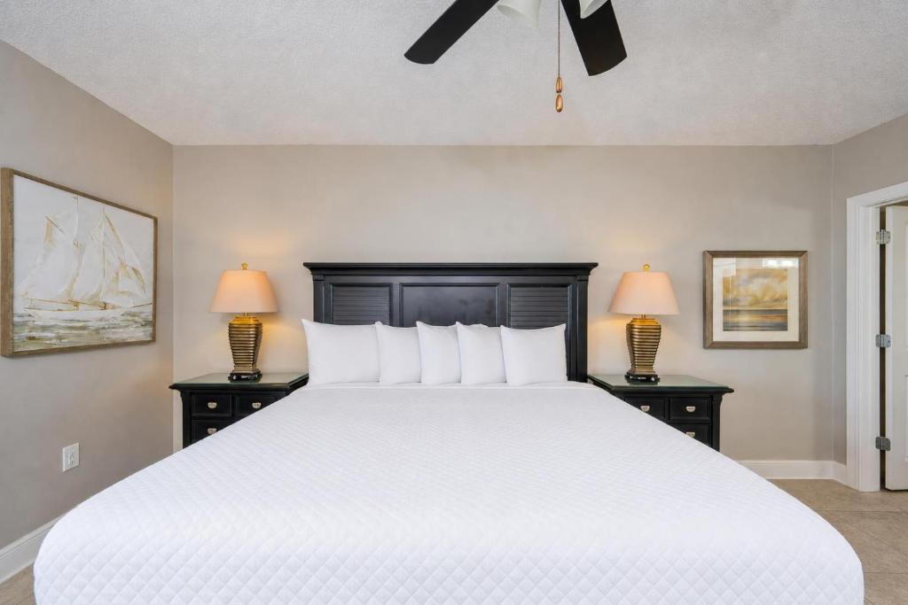a bedroom with a large white bed with two lamps at Phoenix X 506 in Orange Beach