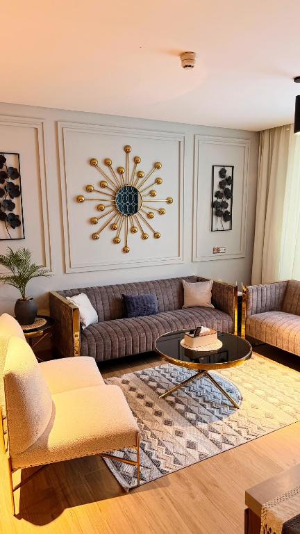 a living room with a couch and a table at Millennium Private Apartment in Salalah