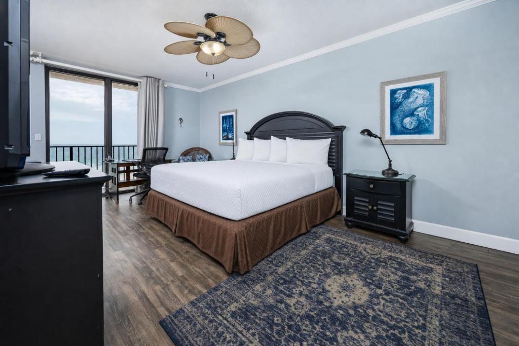 a bedroom with a bed and a ceiling fan at Phoenix X 517 in Orange Beach
