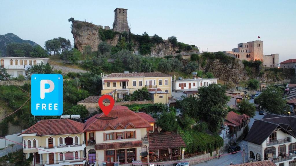 a city with a hill with houses and a sign at Fabiani Boutique Hotel Castle Gate in Krujë