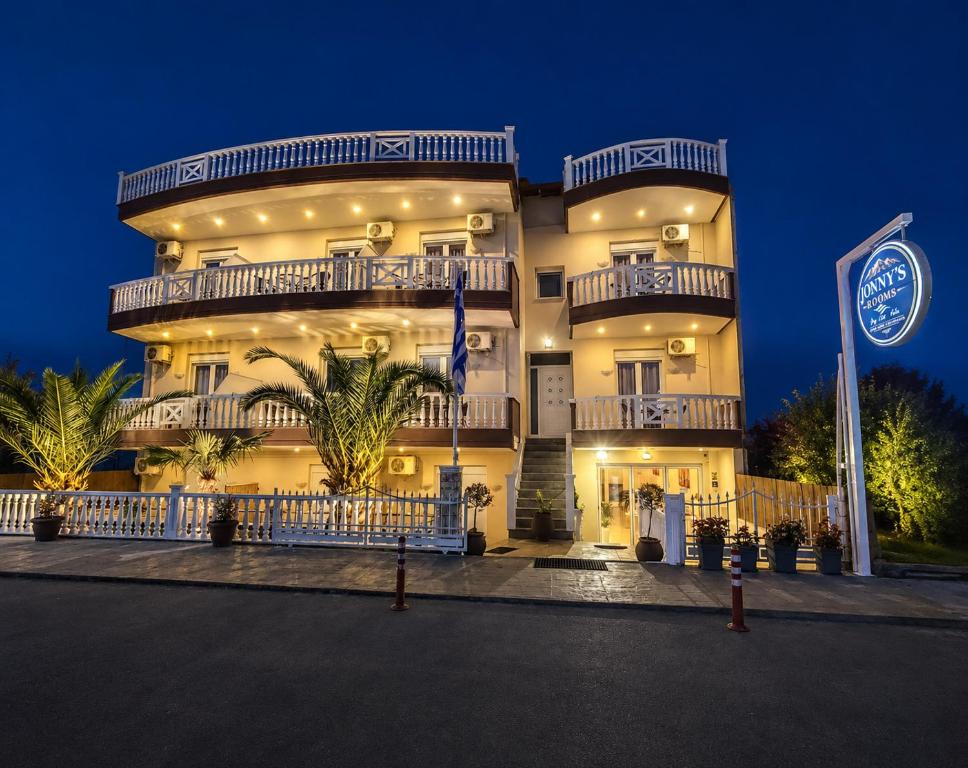a large building with a flag in front of it at JONNY'S Rooms in Paralia Katerinis