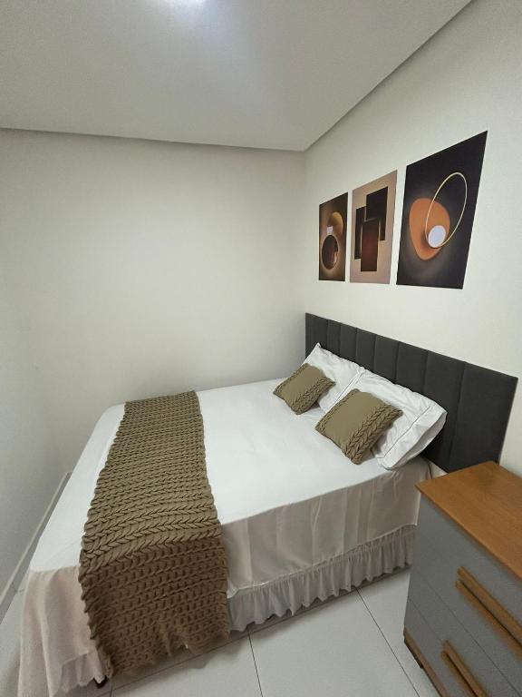 a bedroom with a large bed with two pillows at Casa siles in Mucugê