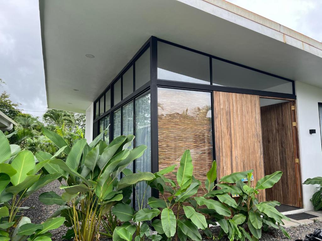 a glass extension to a house with plants at Villa Tanager in Fortuna