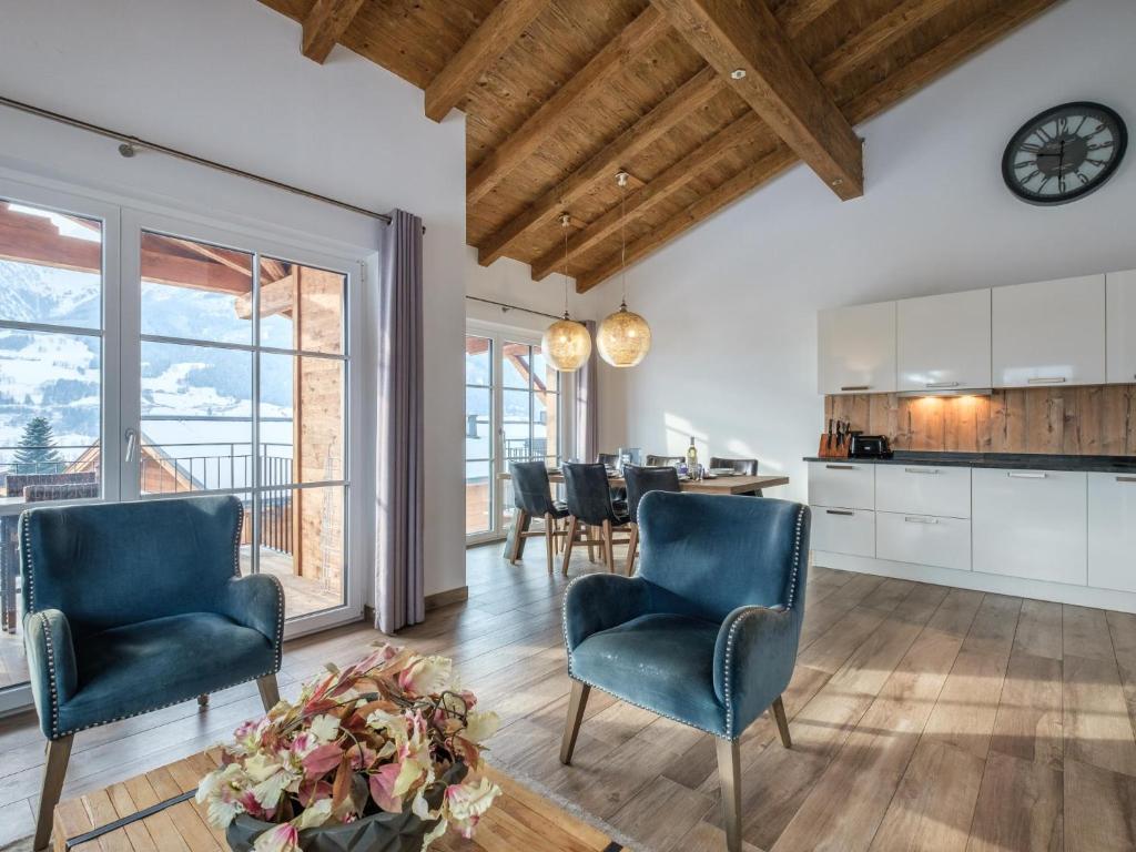 a kitchen and dining room with chairs and a table at Luxury Tauern Suite Walchen Kaprun 8 in Walchen