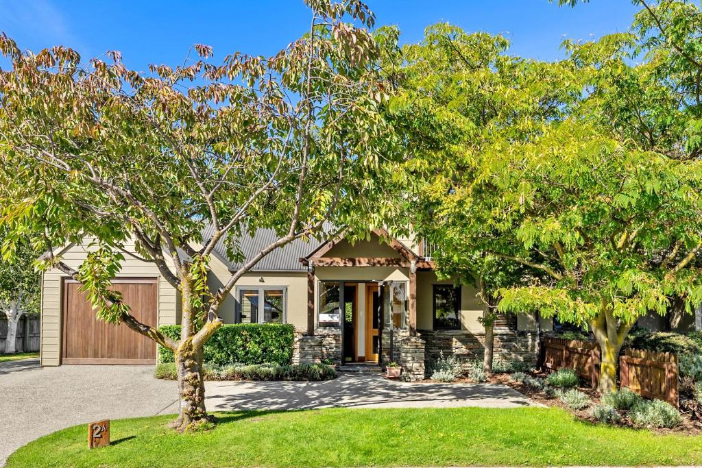 a house with a tree in the front yard at Lansdown Apartments in Wanaka