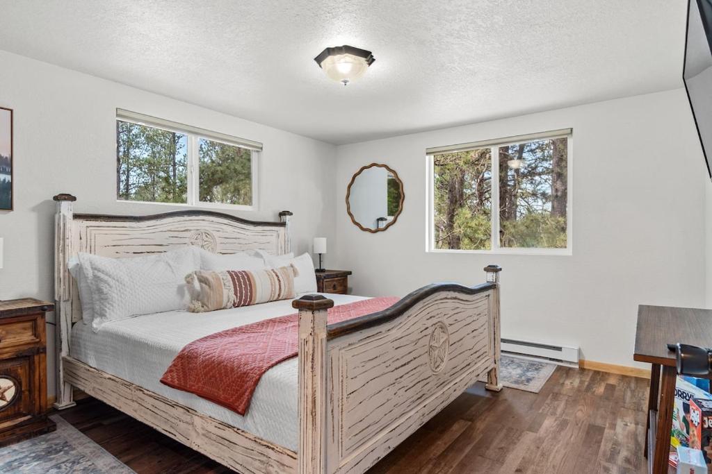 a bedroom with a bed and two windows at Rustic Sanctuary BHBungalows #7 in Custer