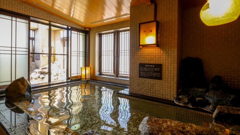 a room with a pool of water in a building at Dormy Inn Asahikawa in Asahikawa