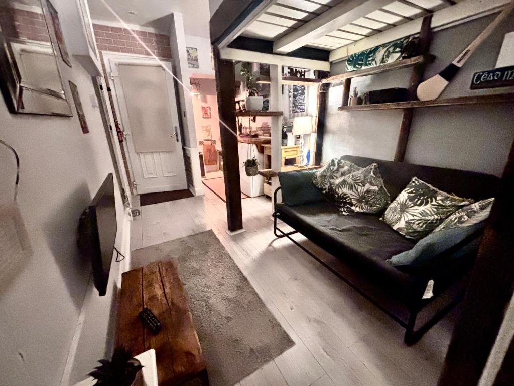 a living room with a couch and a table at Studio at 39 in Dublin