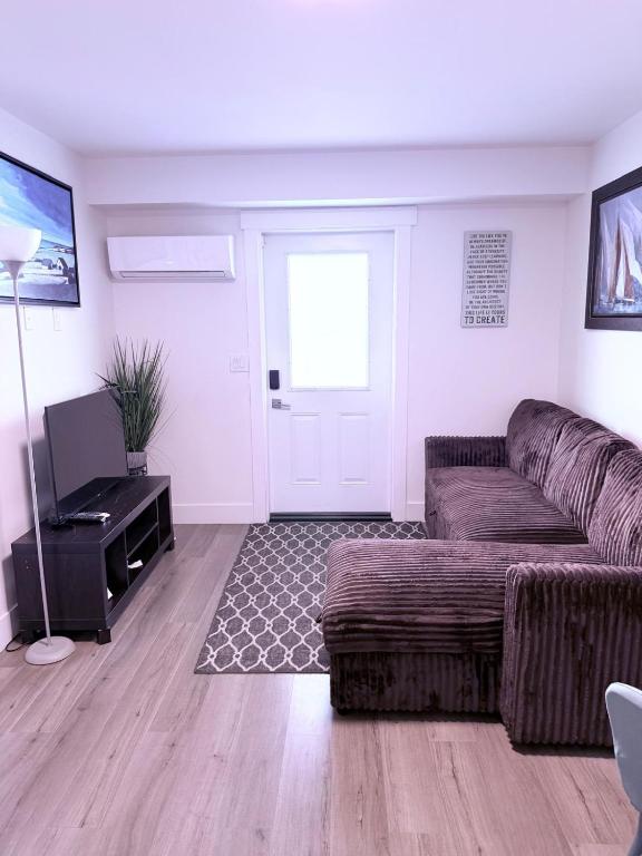 a living room with a couch and a television at Stay with Silvia in Halifax