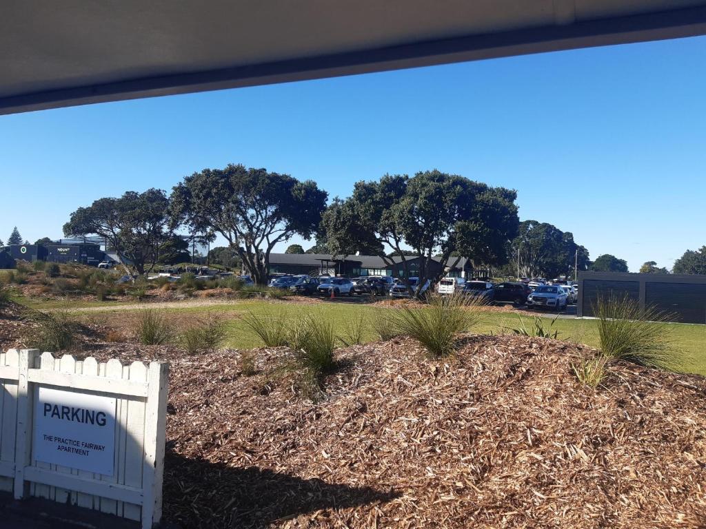 a fence in a yard with a parking lot at The Practice Fairway in Tauranga