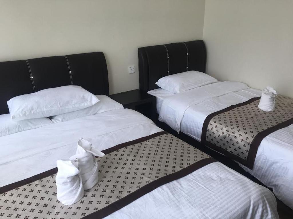 Postel nebo postele na pokoji v ubytování Qu Lin Resident