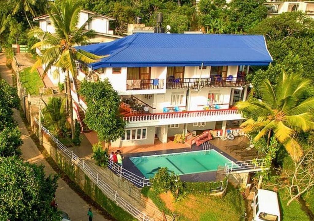 an aerial view of a house with a swimming pool at Blue Haven Hotel in Kandy