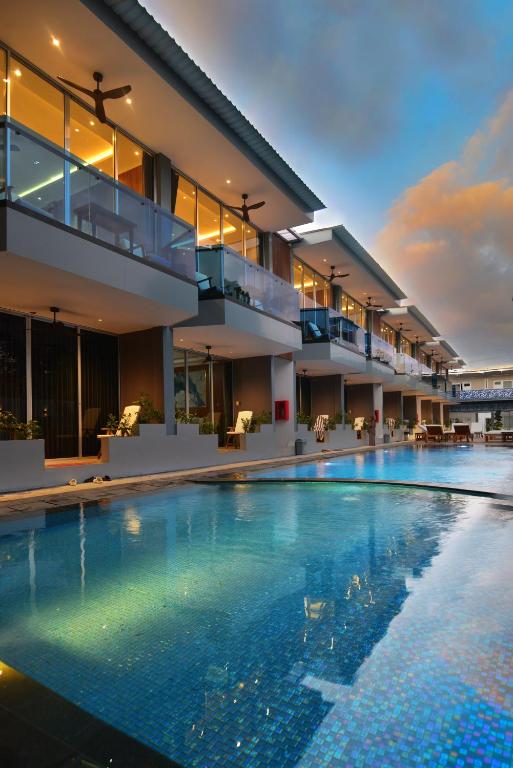 a large swimming pool in front of a building at Lighthouse Hotel in Gili Trawangan