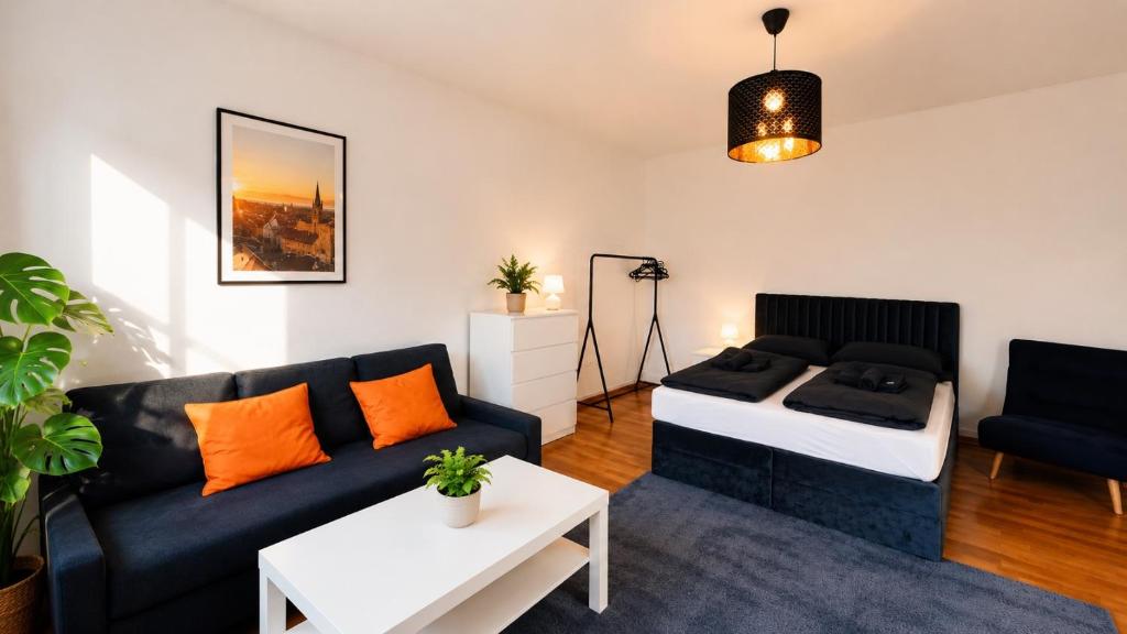 a living room with a couch and a bed at Junior Suite Apartment Eleven in Graz