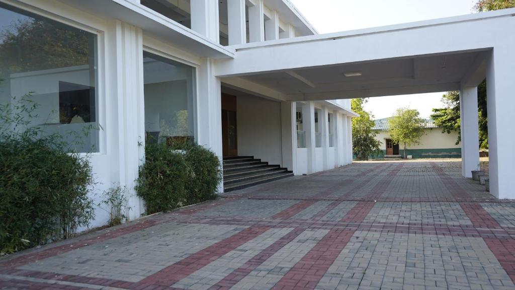 an empty hallway of a white building at The King's Hotel in Tuticorin