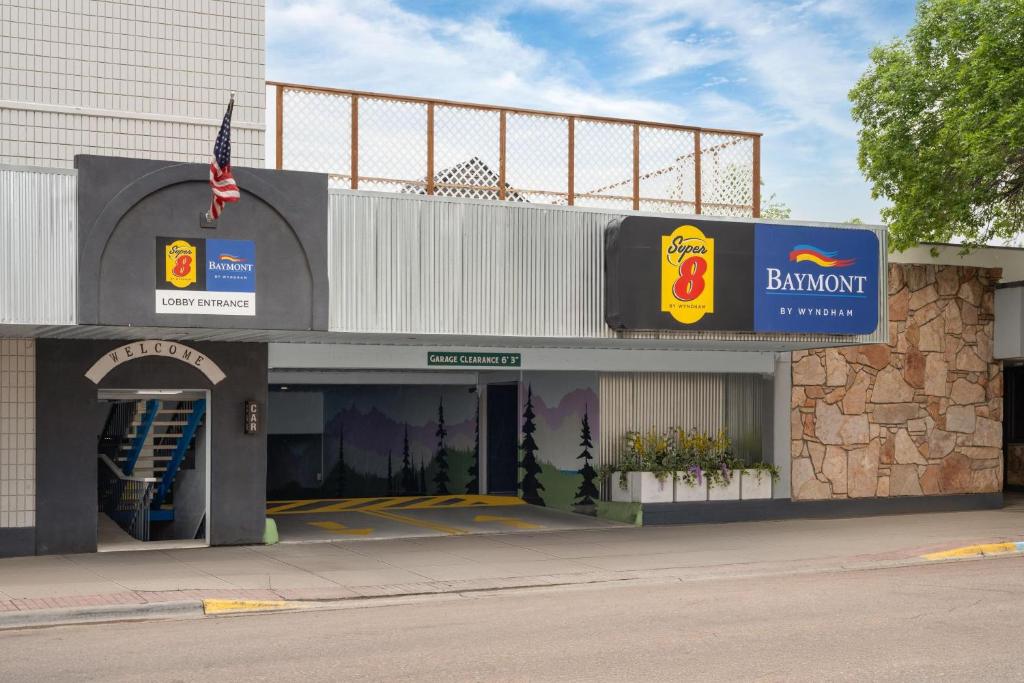 a building with a sign for a bankowment at Baymont by Wyndham Great Falls City Center in Great Falls