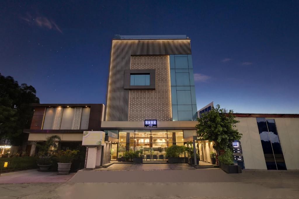 a tall building with a lit up sign on it at Keys Lite by Lemon Tree Hotels, Ajmer in Ajmer