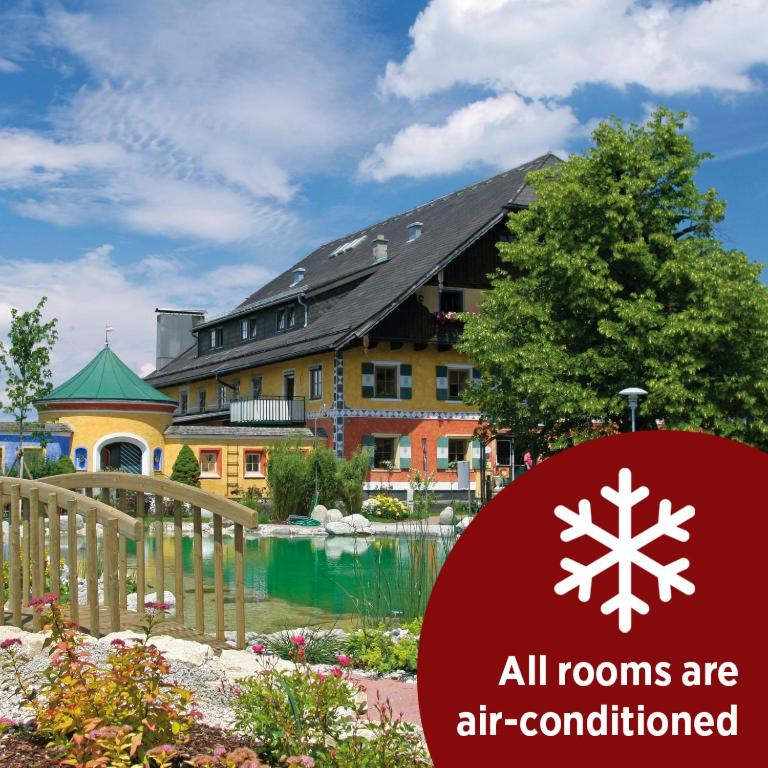 a sign that reads all rooms are air conditioned in front of a building at Gastagwirt in Eugendorf