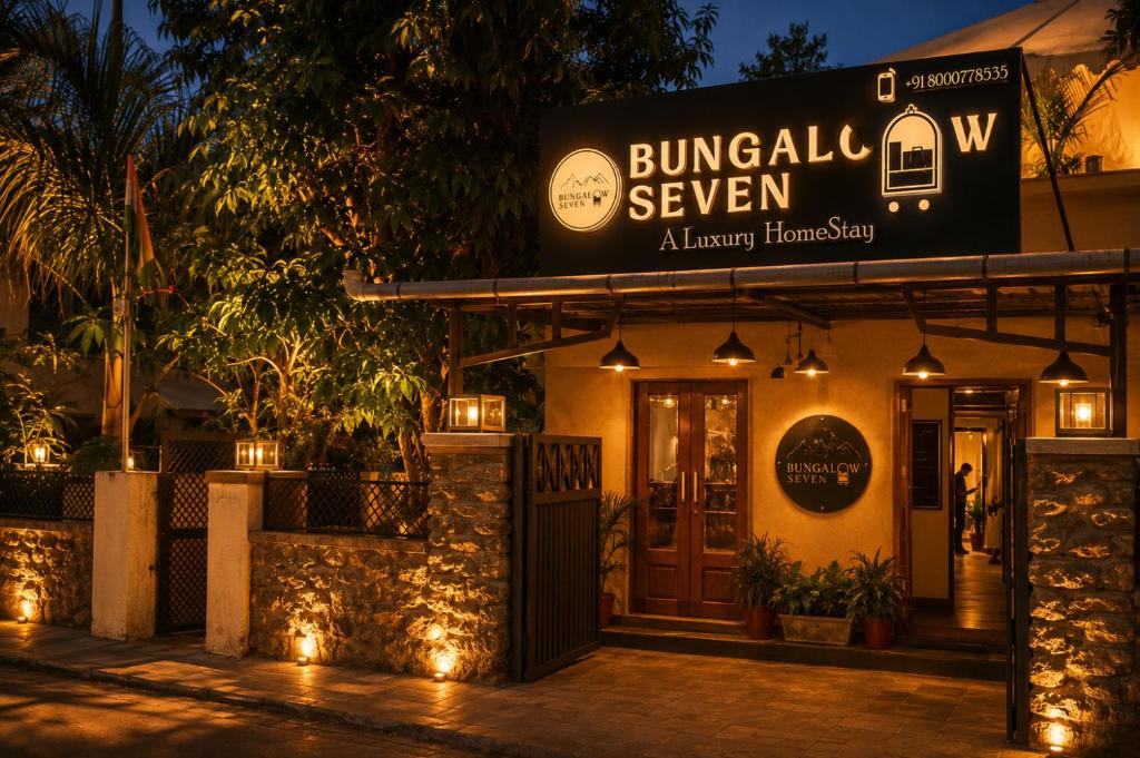 a sign on the front of a building at night at Bungalow Seven Mount Abu in Mount Ābu