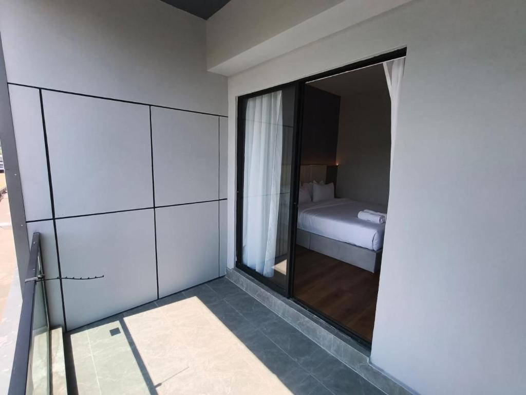 a room with a bedroom with a bed and a mirror at DBC Hotel in Semporna