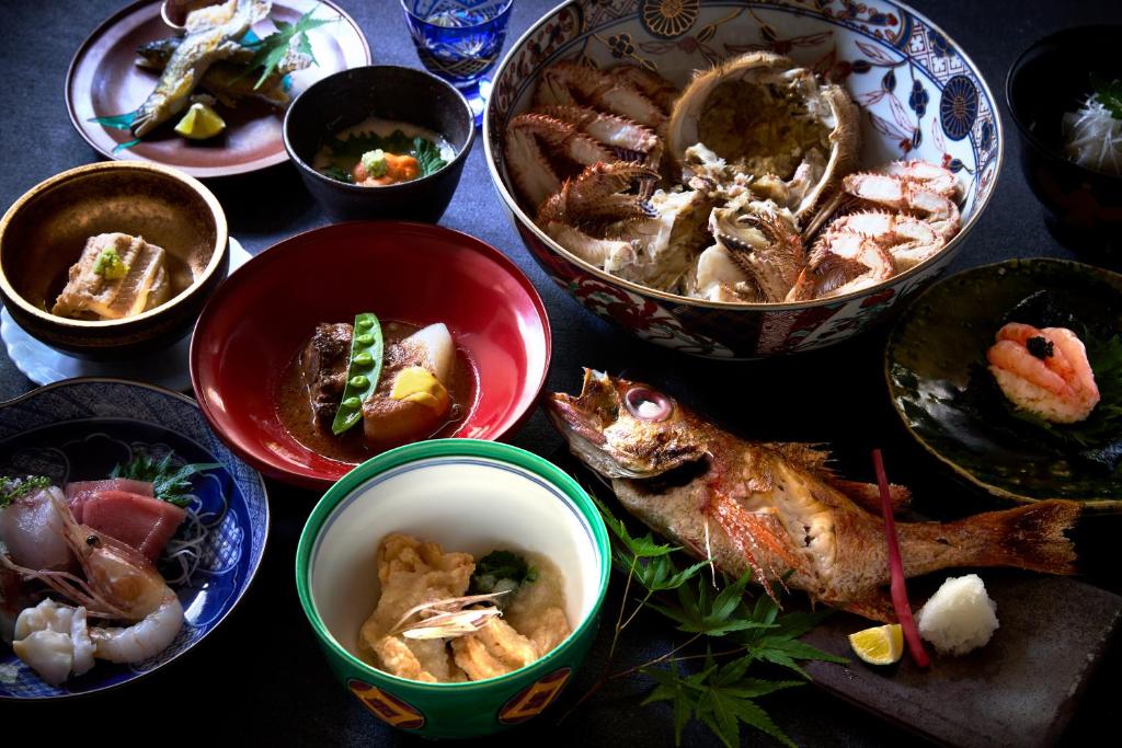 a table topped with bowls of different types of food at Kocho in Kaga