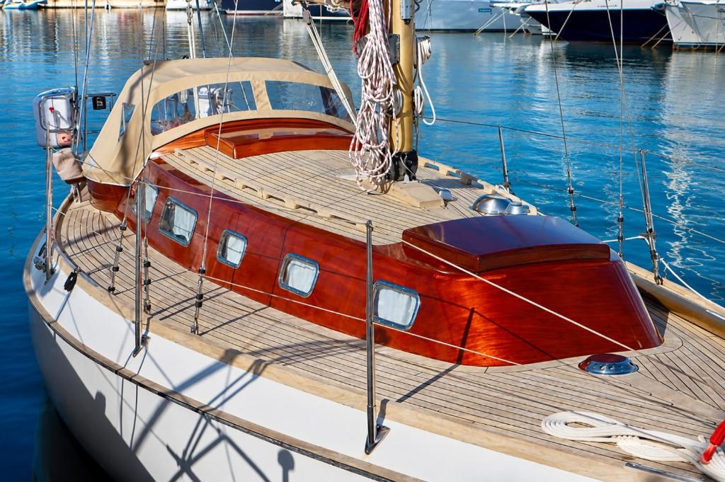 a boat is docked at a dock in the water at Garuda yacht in Nida