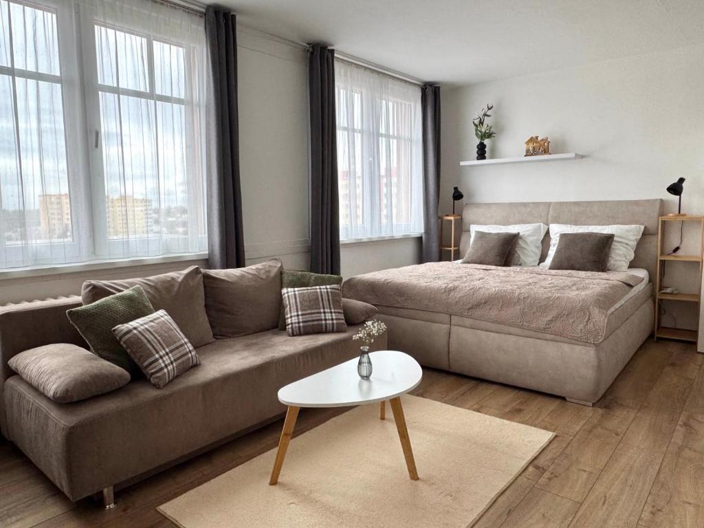 a living room with a couch and a coffee table at Smarty Choice Living with FREE PARKING - Vondroušova in Prague