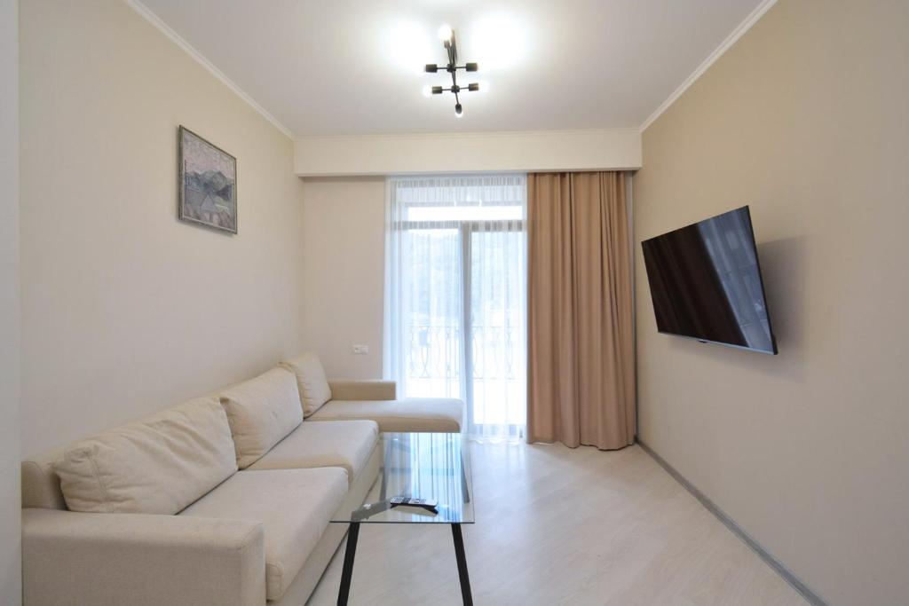 a living room with a couch and a tv at Domel Tsaghkadzor in Tsaghkadzor