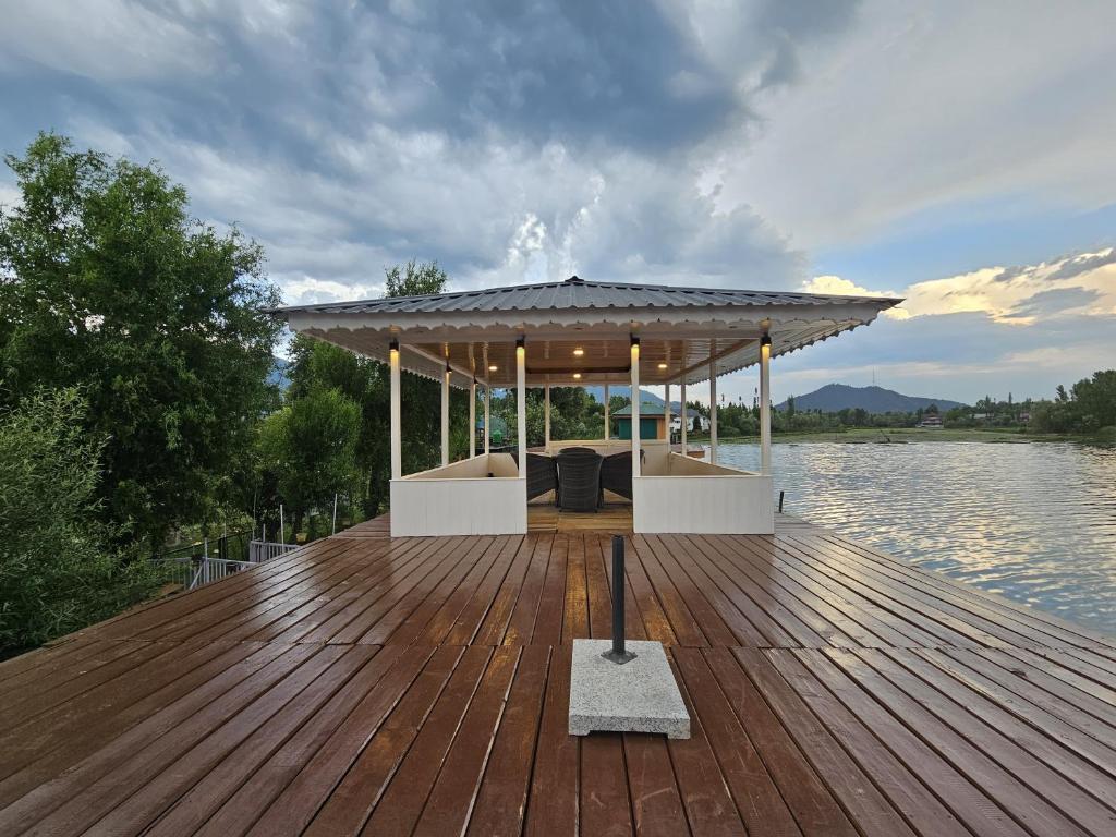 a gazebo on a wooden deck on a body of water at Dilshad Houseboats in Srinagar