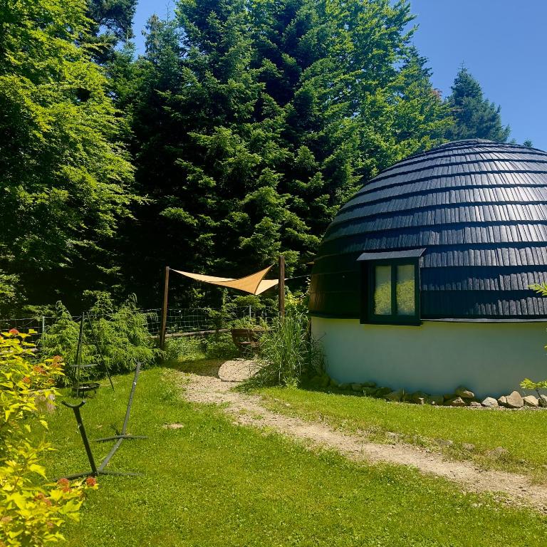 a round building with a blue dome in a yard at GRASÓWKA in Werlas