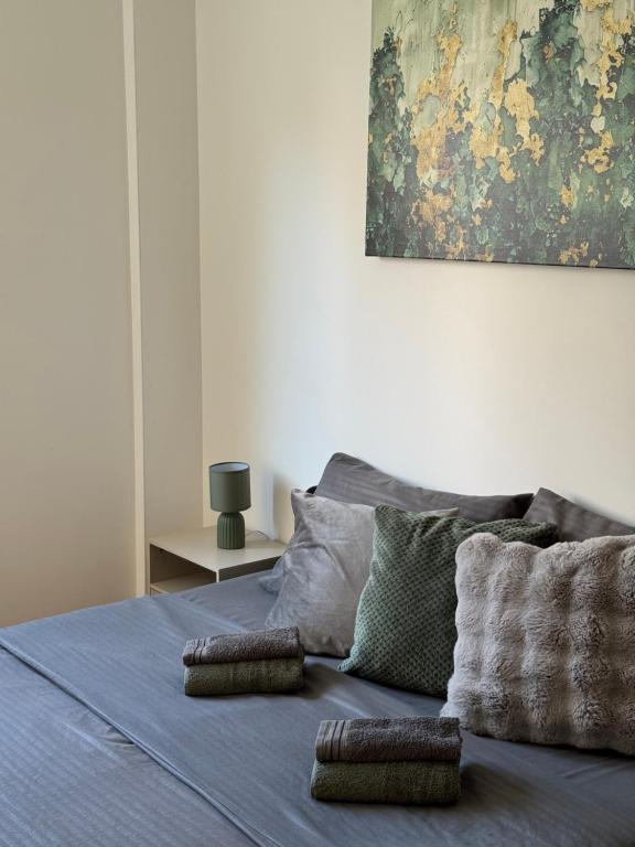 a bed with two pillows on top of it at Apartman Lambros in Soko Banja