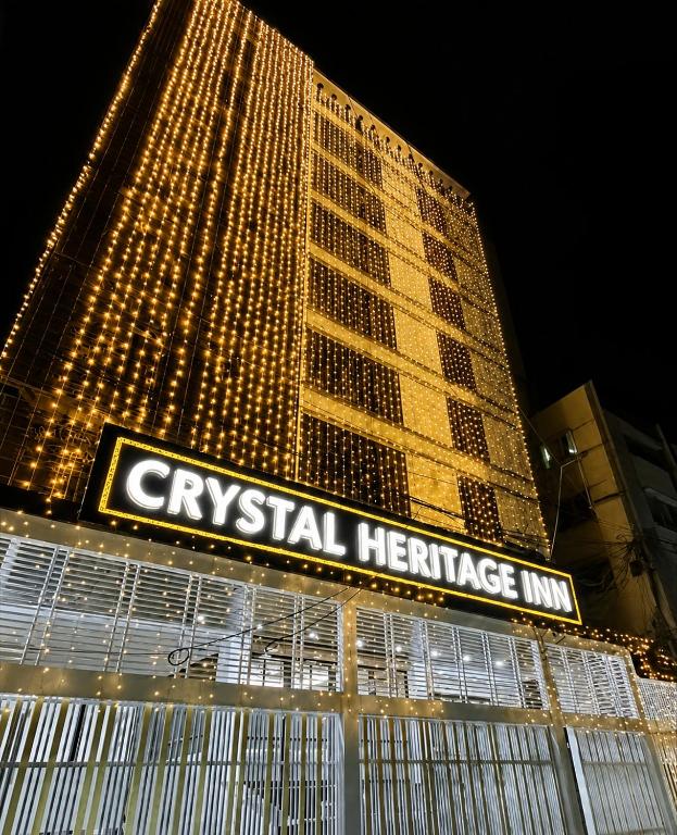 a large building with a sign in front of it at Crystal Heritage Inn in Dhaka