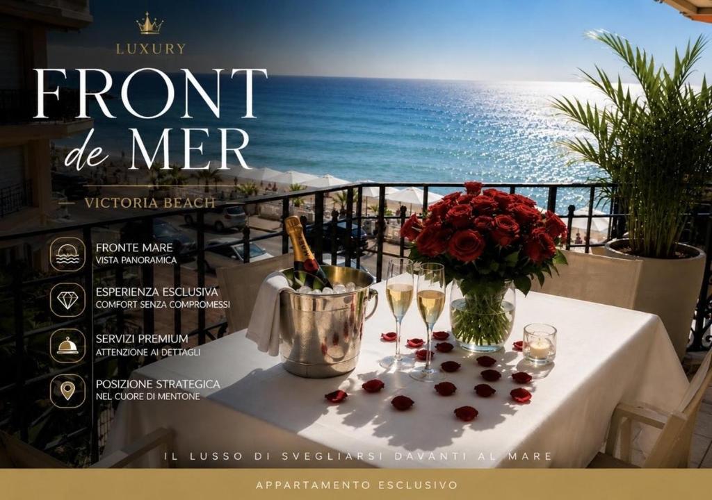 a table with wine glasses and a vase of flowers at Victoria Beach Front de Mer Luxury Apartment in Menton