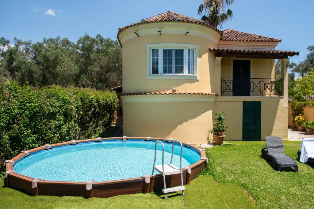 a house with a swimming pool in the yard at Eleas Gi Villa in Vitalades